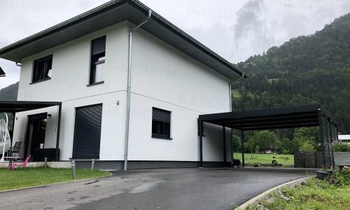 Moderný prístrešok pri bielom rodinnom dome