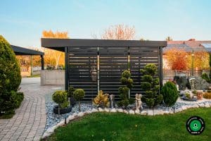 Bočn&aacute; stena pr&iacute;stre&scaron;ku pri okrasn&yacute;ch drevin&aacute;ch a kamienkoch